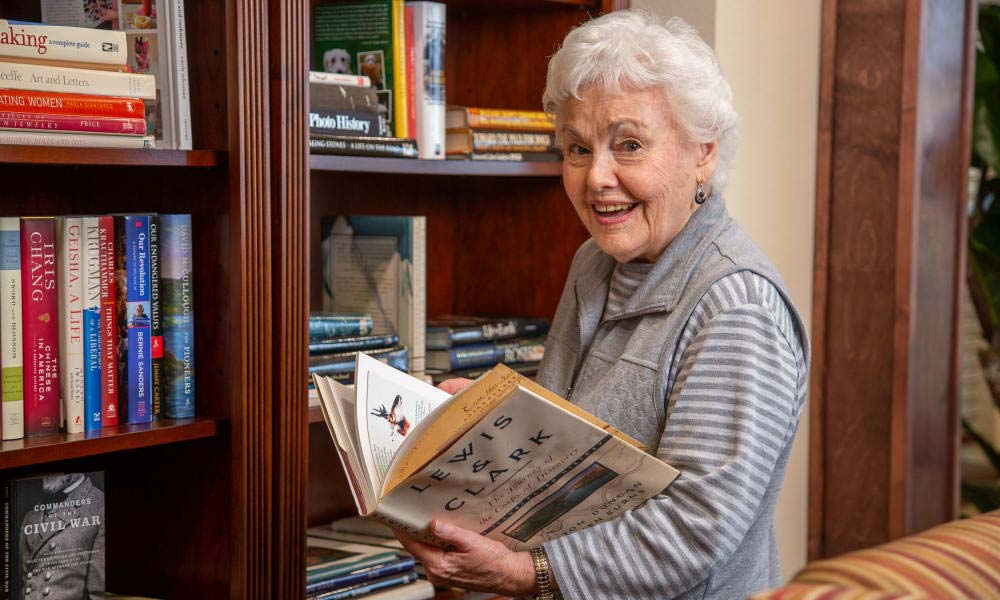 Independent senior in Cedar Park selecting a book
